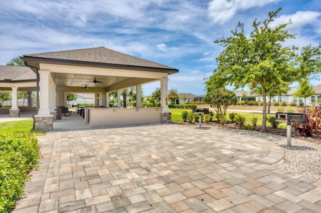 view of patio / terrace with a gazebo, ceiling fan, and an outdoor bar