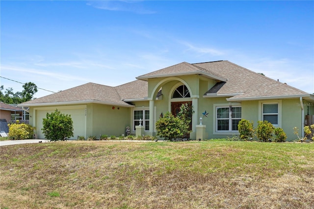 view of front of house featuring a garage and a front yard