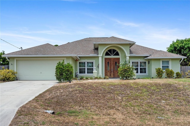 single story home with a front lawn and a garage