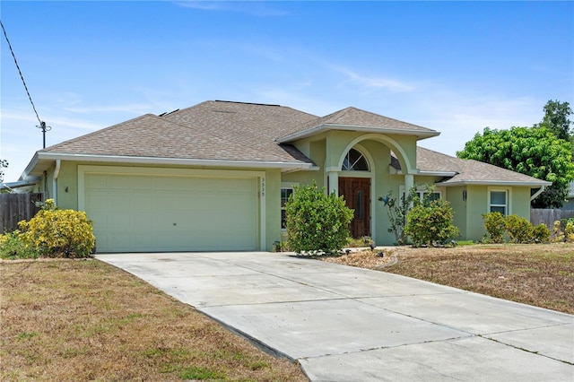 view of front of house with a garage and a front lawn