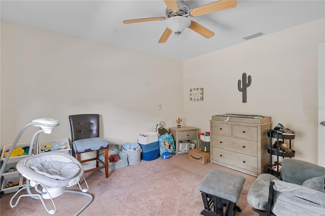 living area featuring ceiling fan and light colored carpet