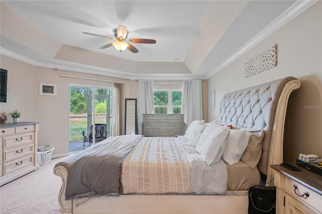 carpeted bedroom featuring access to exterior, a raised ceiling, ceiling fan, and ornamental molding