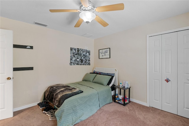 carpeted bedroom featuring ceiling fan and a closet