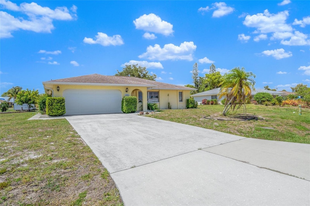 single story home featuring a garage and a front lawn