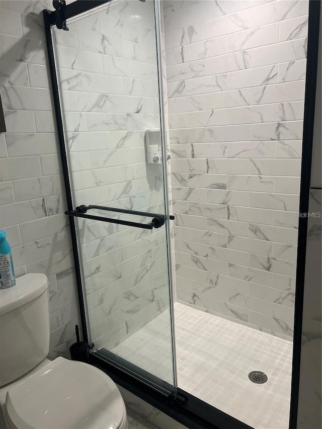 bathroom with walk in shower and toilet