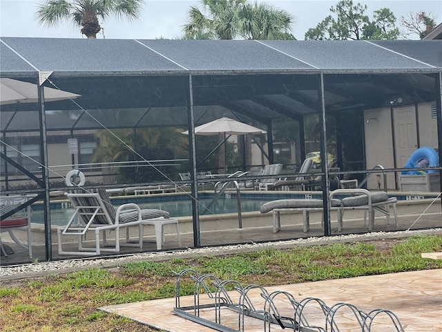 view of pool featuring a patio area and a lanai