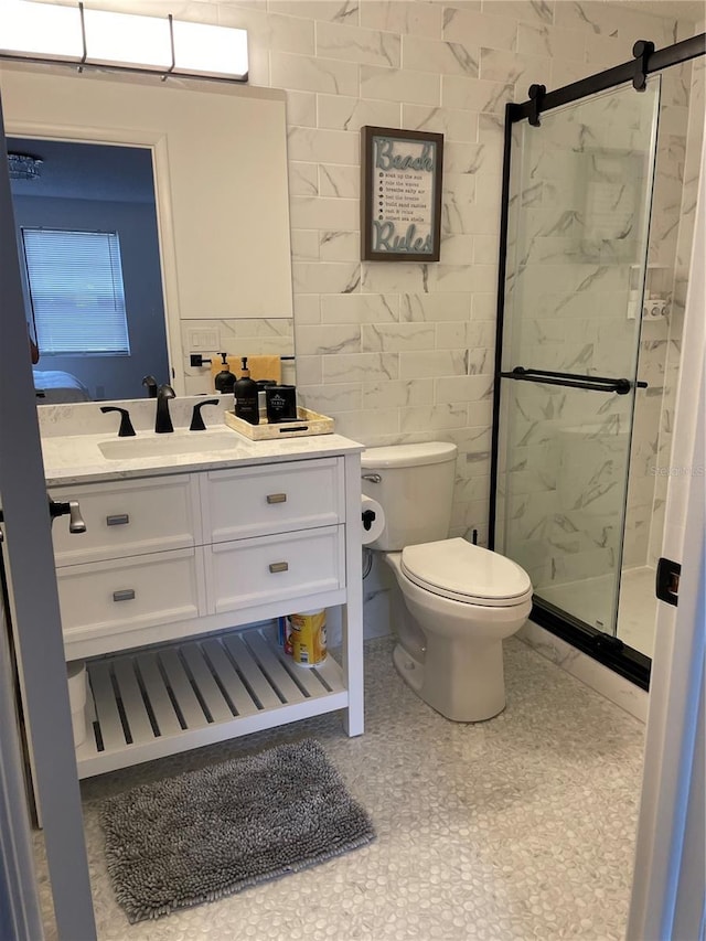 bathroom with vanity, toilet, and an enclosed shower