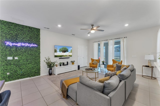 living room featuring light tile patterned floors and ceiling fan