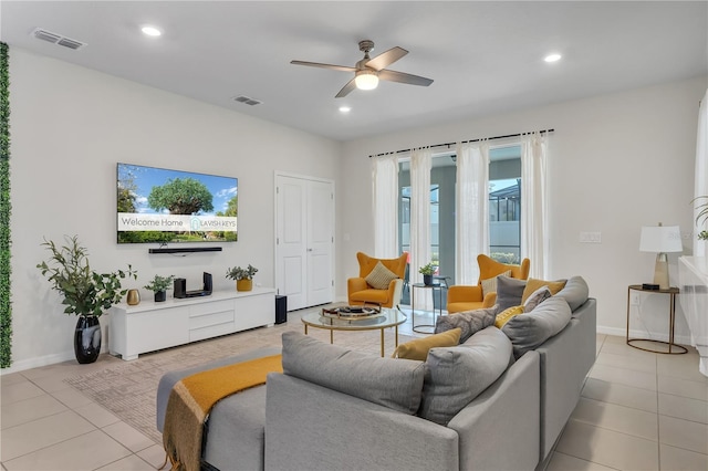 living room with ceiling fan and light tile patterned floors