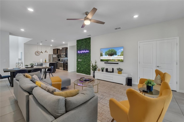 living room featuring ceiling fan and light tile patterned flooring