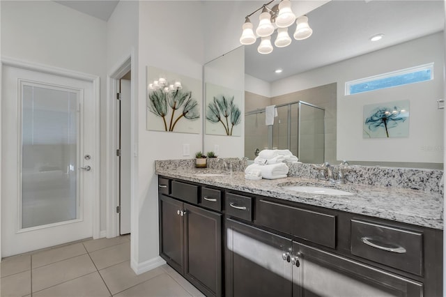 bathroom featuring tile patterned flooring, vanity, a chandelier, and an enclosed shower