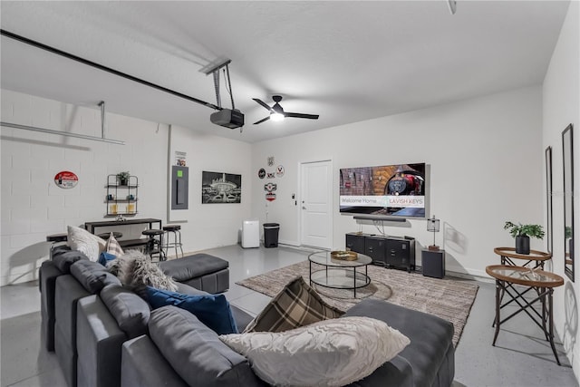 living room with electric panel, ceiling fan, and concrete flooring