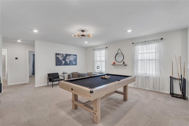 recreation room with a textured ceiling, light carpet, and pool table