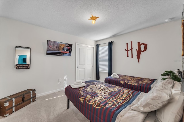 bedroom featuring a textured ceiling and carpet floors