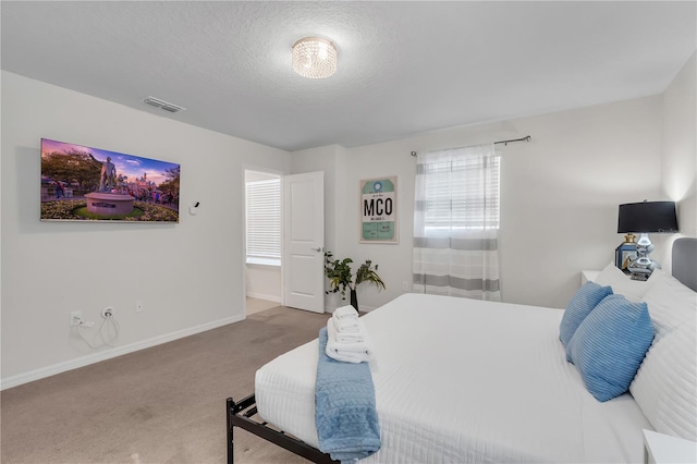 bedroom featuring carpet and a textured ceiling