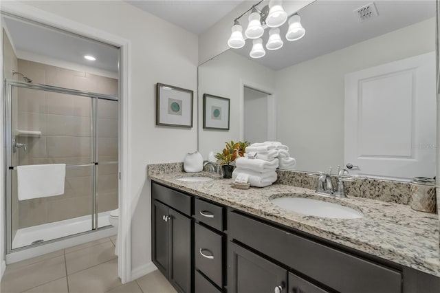 bathroom with toilet, vanity, tile patterned floors, and an enclosed shower