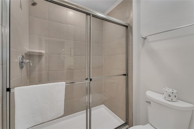 bathroom with toilet and walk in shower