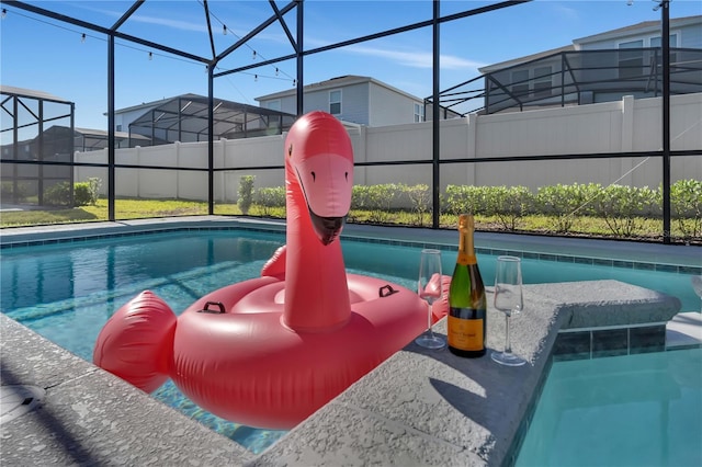 view of swimming pool with a lanai