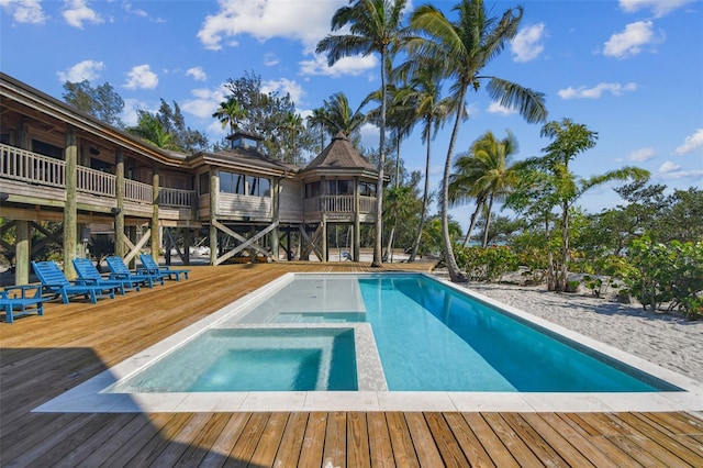 view of pool with a deck and an in ground hot tub