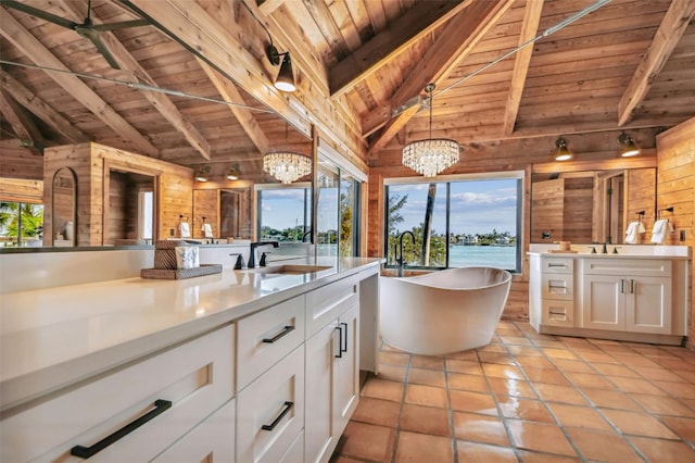 kitchen with a wealth of natural light, white cabinetry, and pendant lighting