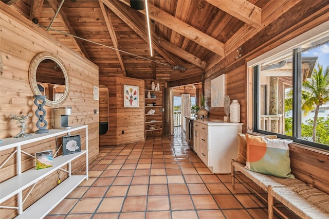 interior space featuring beam ceiling, wooden ceiling, wooden walls, and light tile patterned flooring