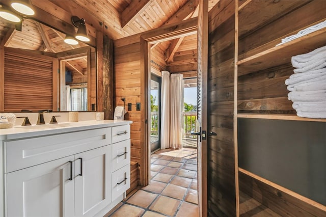 bathroom featuring vaulted ceiling with beams, wood walls, wood ceiling, and vanity