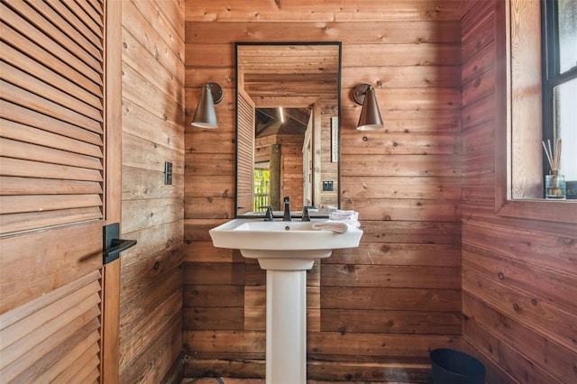 bathroom featuring wood walls