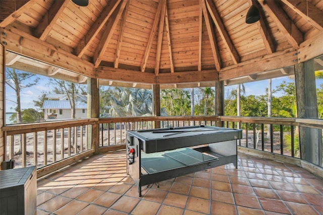 sunroom / solarium with vaulted ceiling with beams, wood ceiling, and billiards