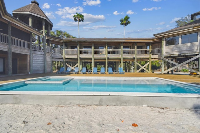 view of pool with an in ground hot tub