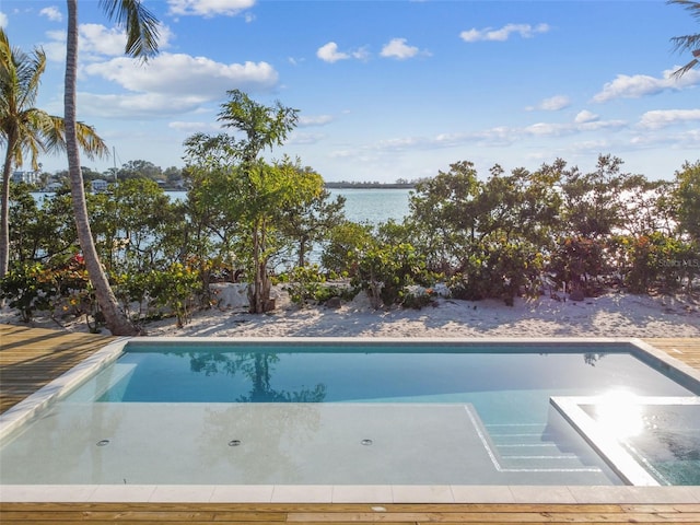 view of pool with a water view