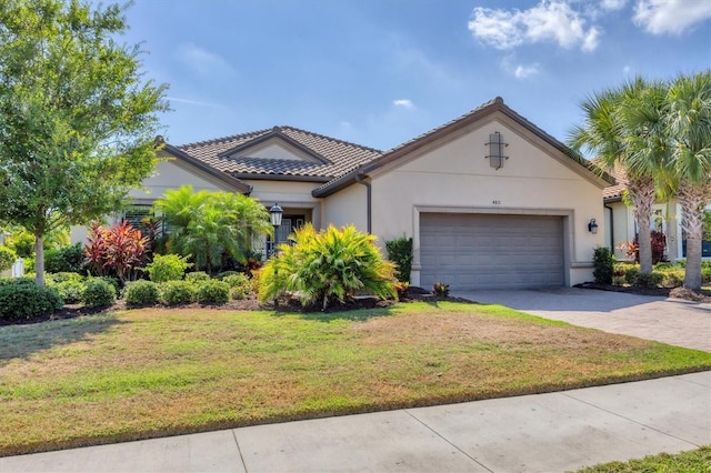 view of front of house featuring a front yard and a garage