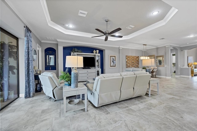 living room with ceiling fan, a raised ceiling, and ornamental molding