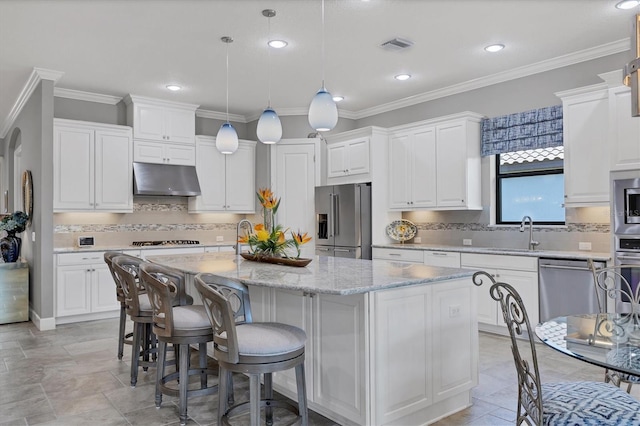 kitchen with white cabinets, stainless steel appliances, and a center island with sink