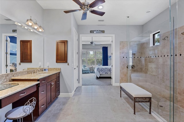 bathroom with vanity and tiled shower