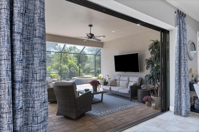 view of patio / terrace featuring ceiling fan, a lanai, an outdoor living space, and an in ground hot tub