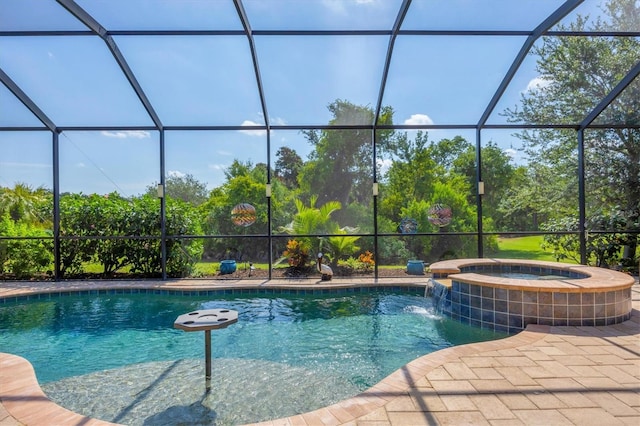 view of pool featuring pool water feature, a patio area, a lanai, and an in ground hot tub