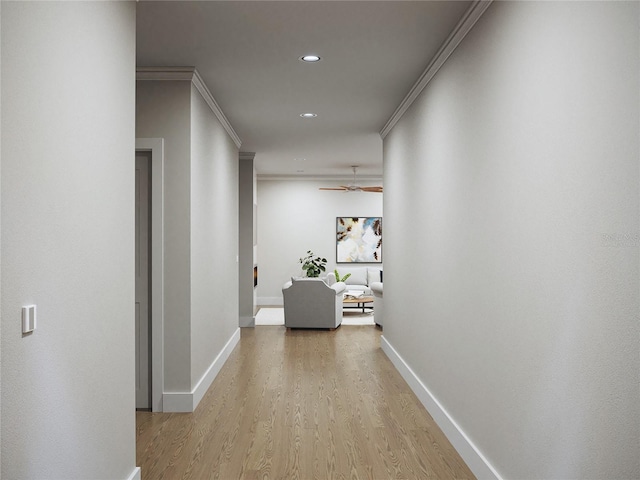 corridor with light wood-type flooring and ornamental molding