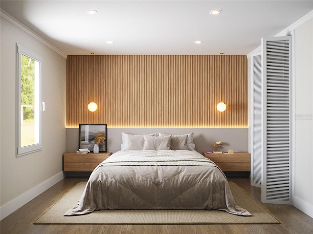 bedroom with crown molding and hardwood / wood-style flooring