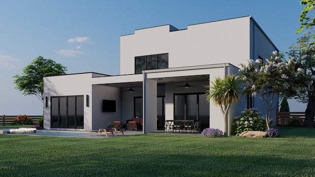 rear view of property featuring a yard, a patio area, and ceiling fan