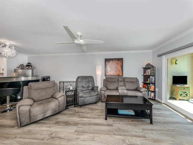 living room with light hardwood / wood-style flooring, ceiling fan, and ornamental molding