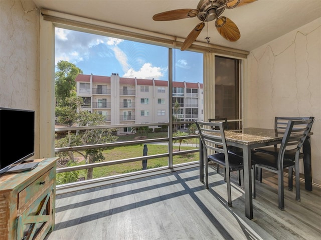 exterior space with ceiling fan