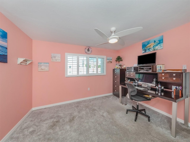 carpeted office space with ceiling fan