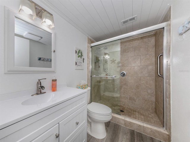 bathroom with vanity, wooden ceiling, hardwood / wood-style floors, toilet, and a shower with shower door