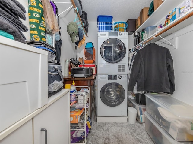 laundry room featuring a textured ceiling, carpet floors, and stacked washing maching and dryer