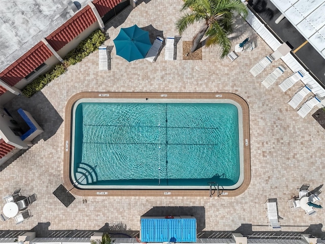 community pool with a patio area