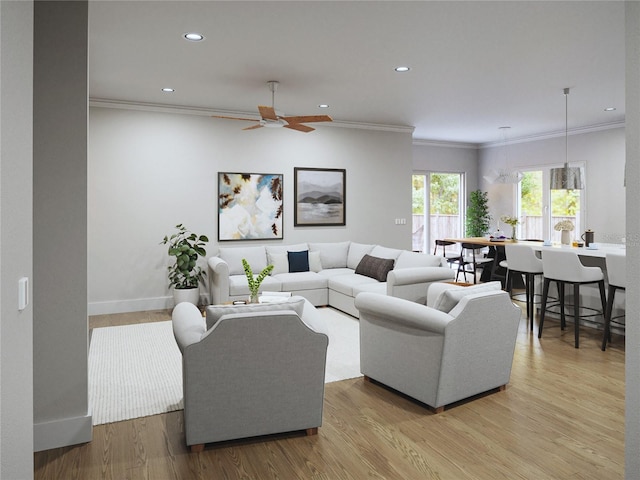 living room with crown molding, ceiling fan, and light wood-type flooring