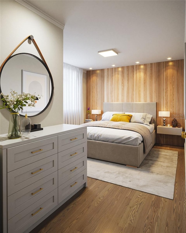 bedroom with dark hardwood / wood-style flooring and ornamental molding