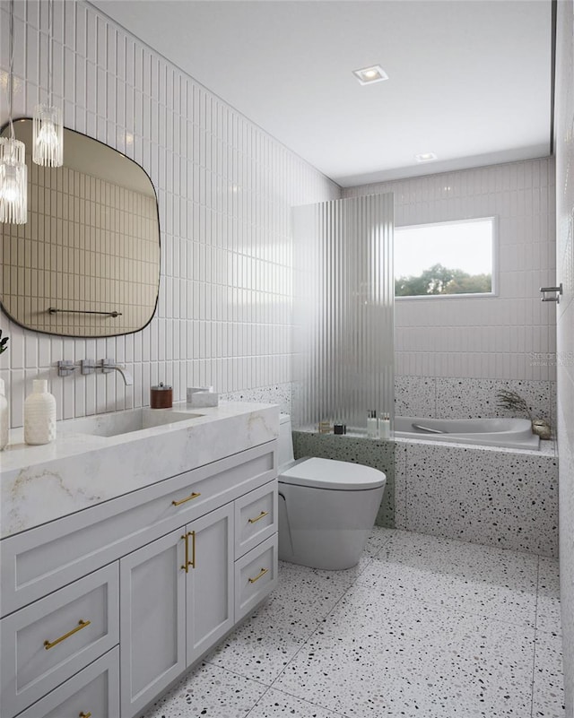 bathroom featuring decorative backsplash, vanity, tile walls, toilet, and a bathing tub