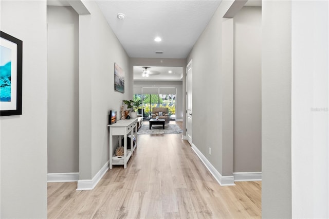 hallway with light hardwood / wood-style flooring