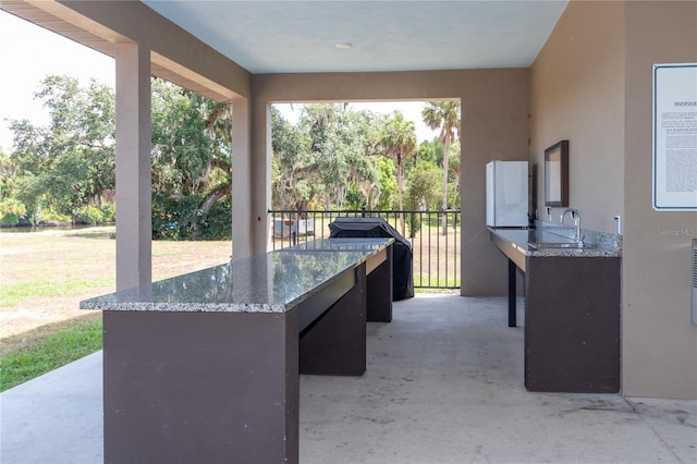 view of patio / terrace featuring an outdoor wet bar